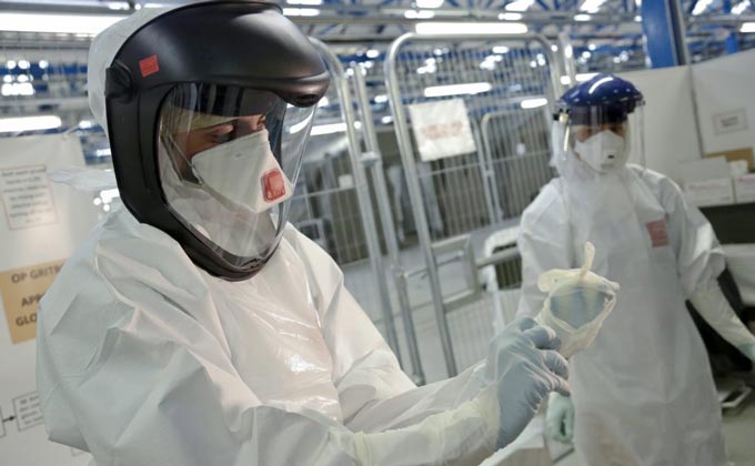 Two people in hazmat suits testing for mold